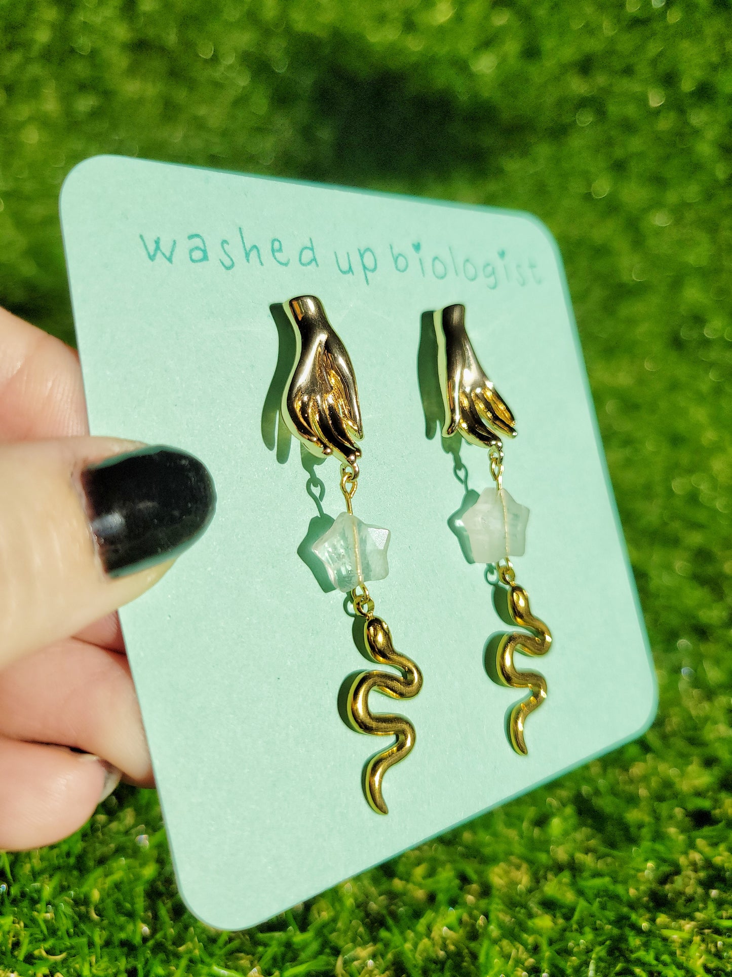 gold hand and snake earrings