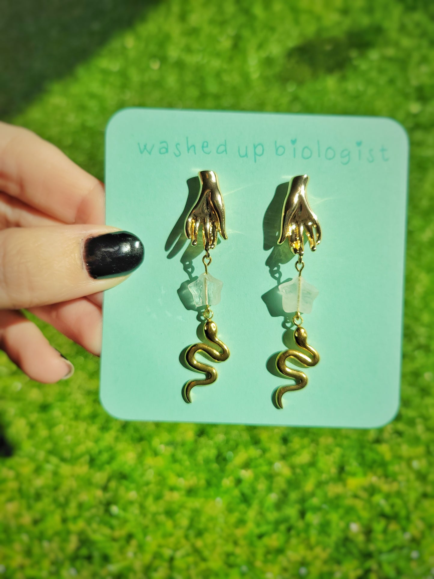 gold hand and snake earrings