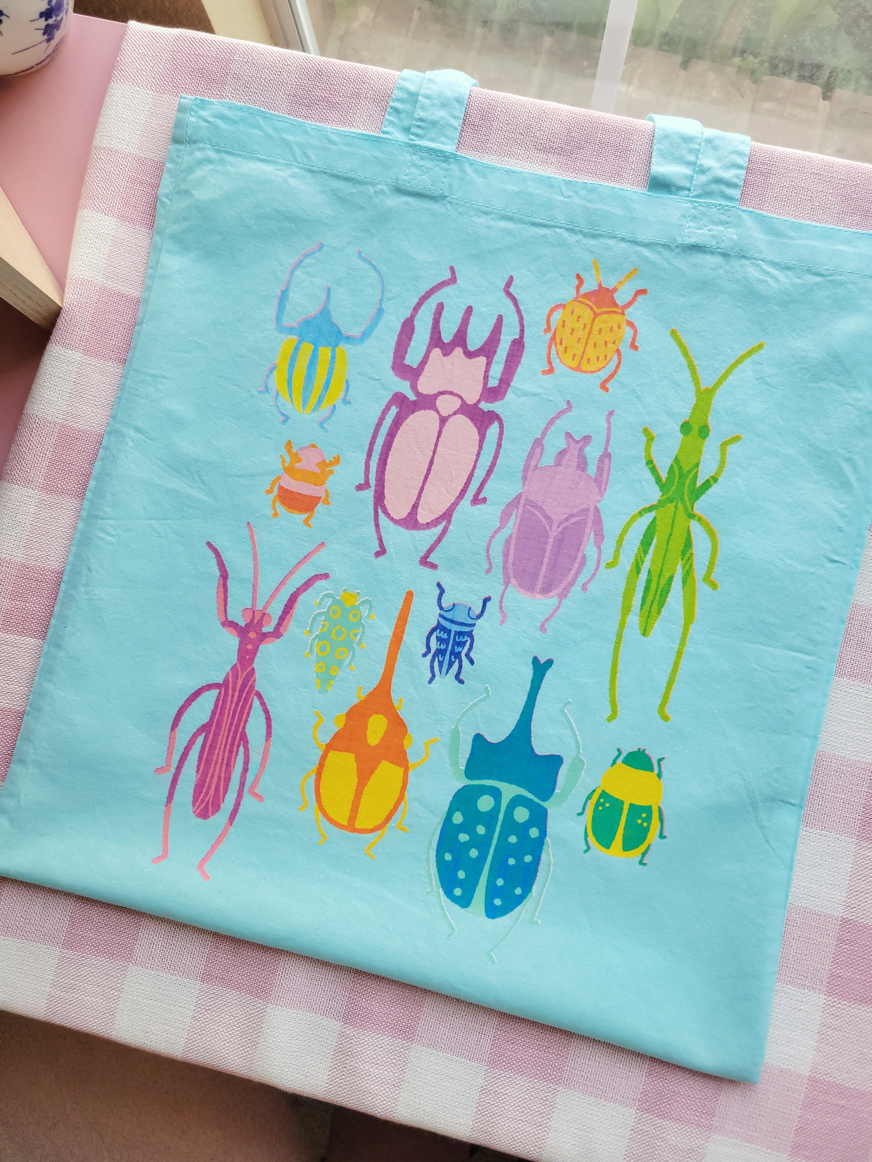 bright bugs light blue lightweight tote bag heat pressed