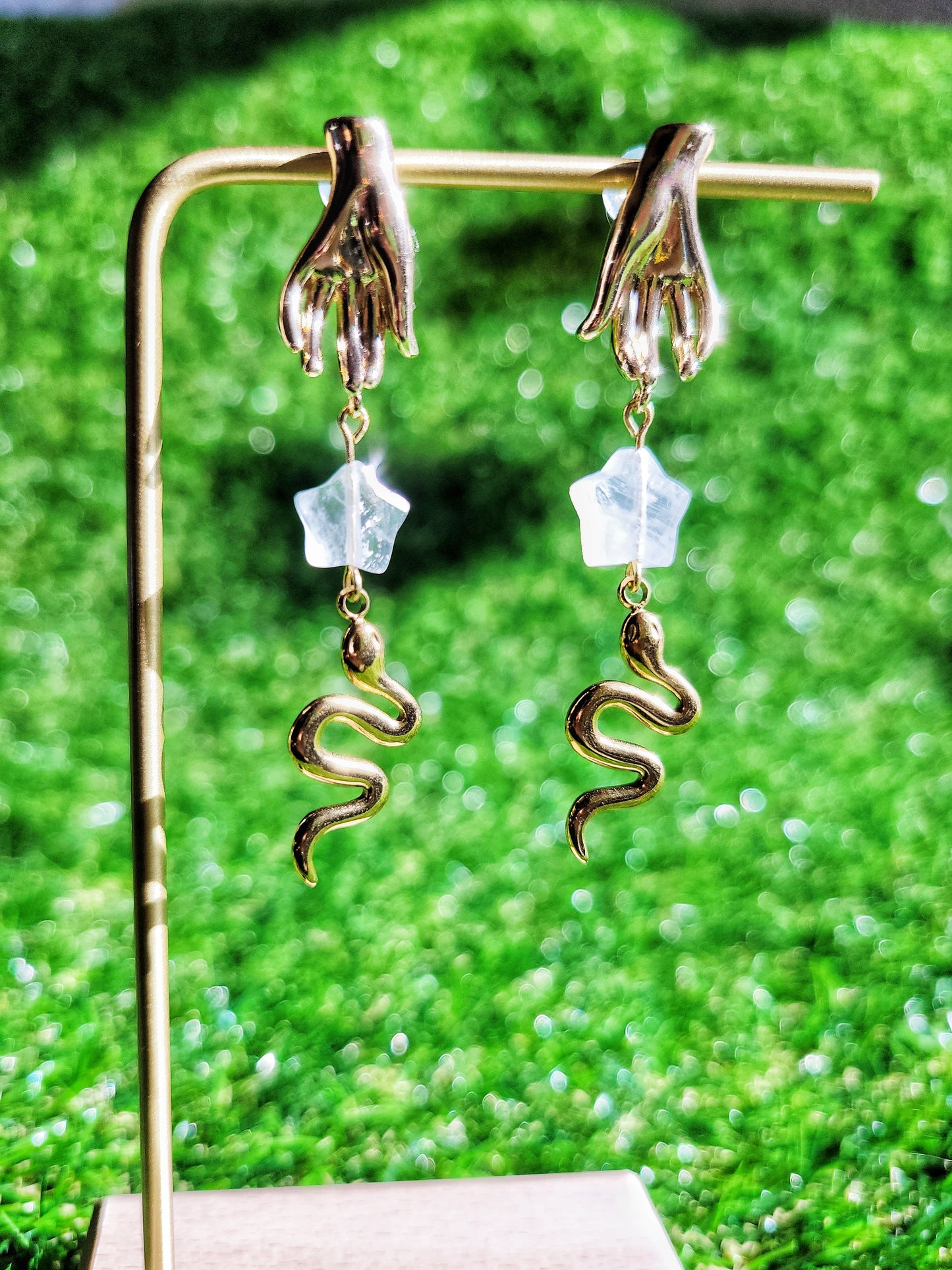 gold hand and snake earrings